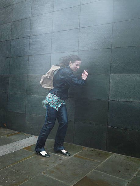 young-woman-on-street-caught-in-rainstorm-eyes-closed-picture-id200397936-001.jpg